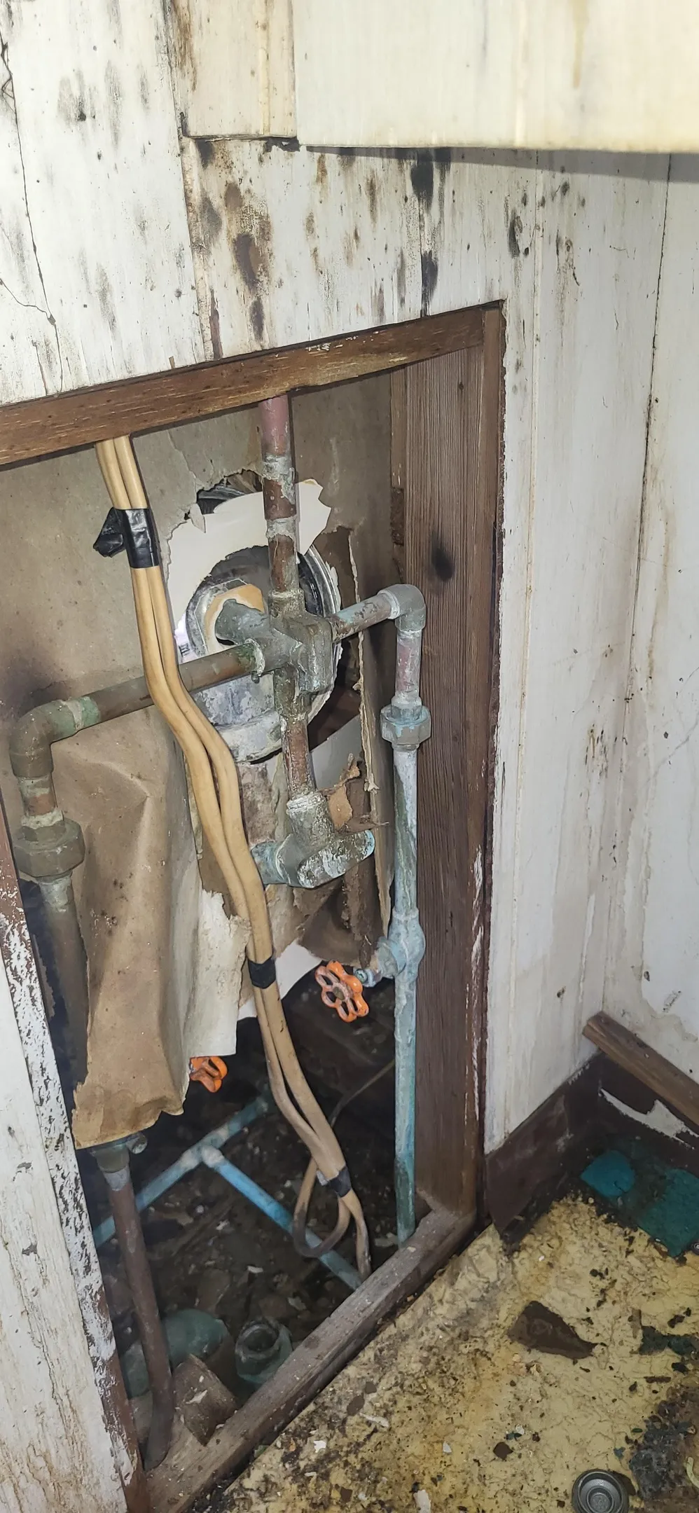 Behind the tub wall
